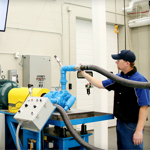 lab technician running quality tests on a pump